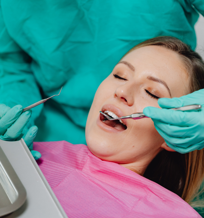 Dental professional performing a gentle cleaning on a patient in a pediatric dental office, showcasing a child-friendly environment with bright colors and dental tools.